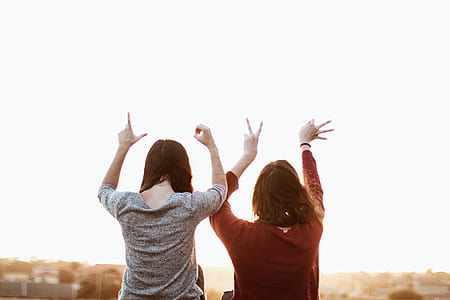 two female making LOVE hand sign thumbnail