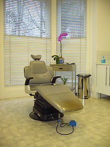 gray patients chair near window with blinds thumbnail