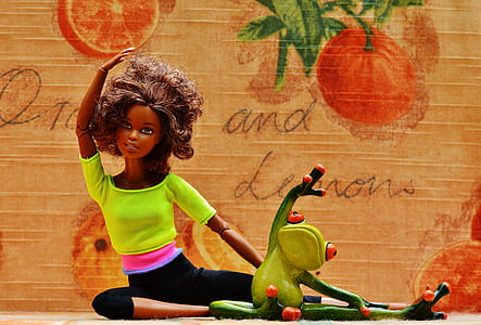 green ceramic frog and girl doll stretching thumbnail