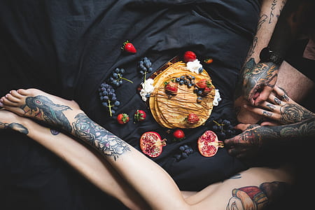 woman lying down in bed with grapes thumbnail