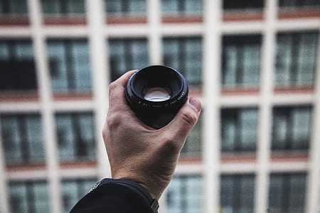 person holding black teleconverter thumbnail