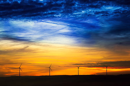 landscape photography of blue and yellow clouds in front of four windmills thumbnail