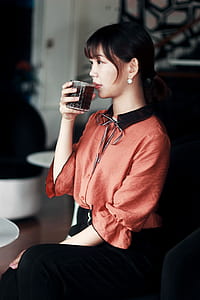 Woman in Pink and Black Dress Drinking Cola thumbnail