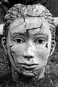 grayscale photography of cracked head bust on ground thumbnail