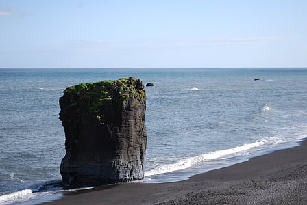 gray monolith near body of water thumbnail