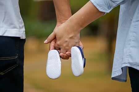 man and woman holding hands and holding pair of blue shoes thumbnail