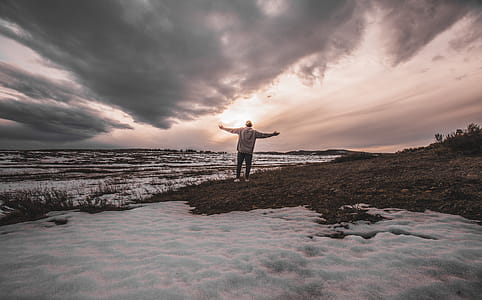Person Standing on Snowy Field thumbnail