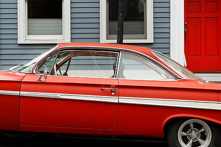 red car parked near house thumbnail