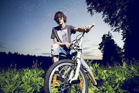 man riding bike on green grass field thumbnail