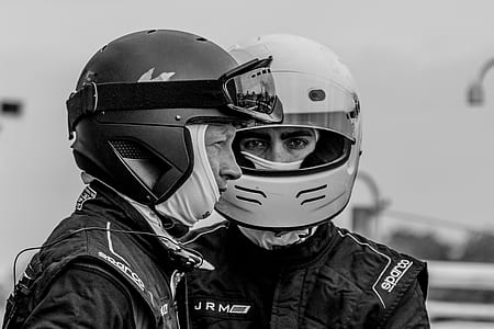 grayscale photography of two men wearing helmets thumbnail