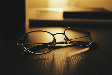 black framed eyeglasses on black surface thumbnail