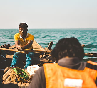 man riding on boat on sea thumbnail