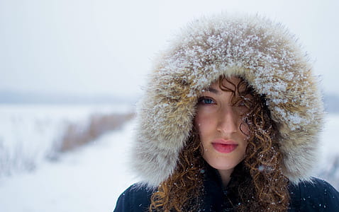 woman wearing blue an beige parka hooded jacket thumbnail