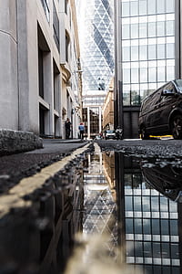 low angle photo of minivan on concrete road with water thumbnail