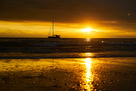 silhouette of sailboat on body of water during sunset thumbnail