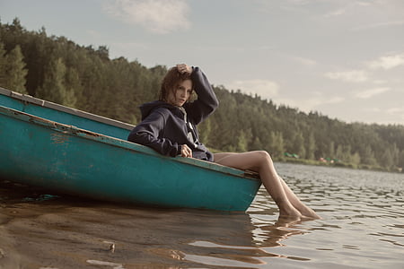 woman sitting on teal boat thumbnail