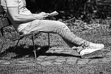 grayscale photography of person sitting on bench thumbnail