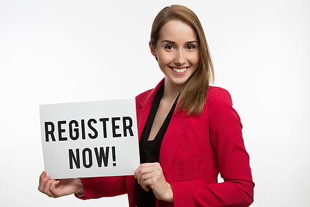 woman wearing red blazer holding register now signage thumbnail