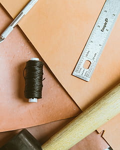 black thread roll on brown surface thumbnail