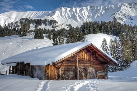 landscape photography of house near mountain filled with snow thumbnail