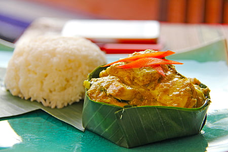cooked food inside banana leaf and cooked rice thumbnail