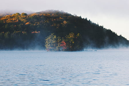 landscape photography of body of water beside mountain thumbnail