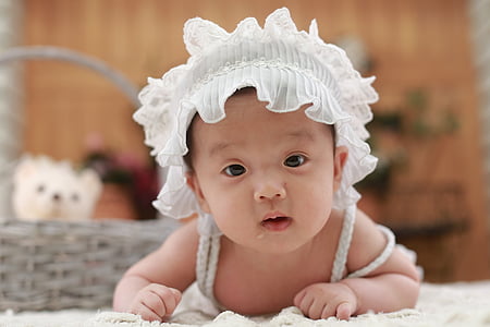 baby wearing white hat thumbnail