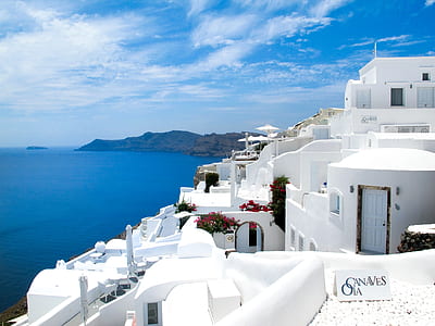 white concrete house near body of water thumbnail