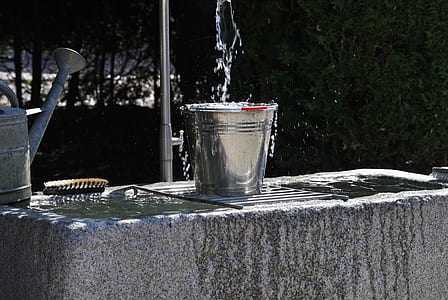 gray stainless-steel bucket on gray concrete surface thumbnail