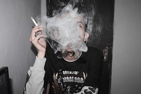 person holding white cigarette stick thumbnail