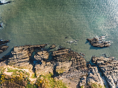 bird's-eye view photography of mountain near body of water thumbnail