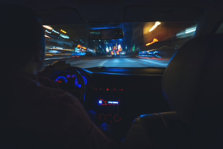 Man driving a car on the road at night thumbnail
