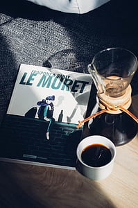 Le Muret book beside white mug thumbnail