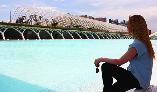 woman holding brown sunglasses beside body of water thumbnail