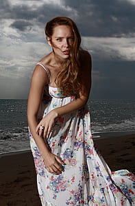 woman posing near seashore at sunset thumbnail