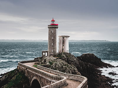 gray concrete lighthouse and ocean view during daytime thumbnail
