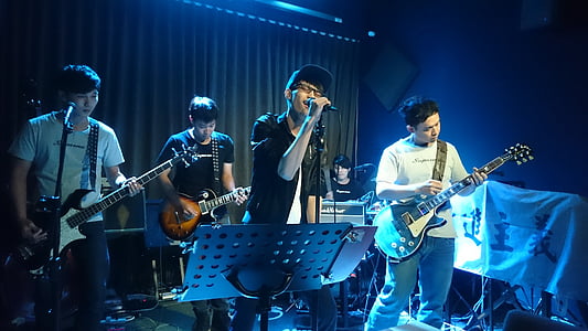 group of band performing on stage thumbnail