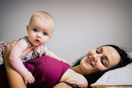 toddler lying on woman's stomach thumbnail