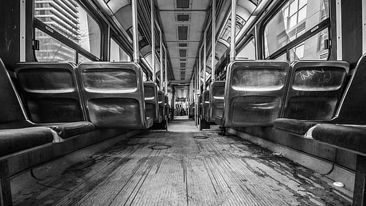 grayscale photo of seats inside train thumbnail