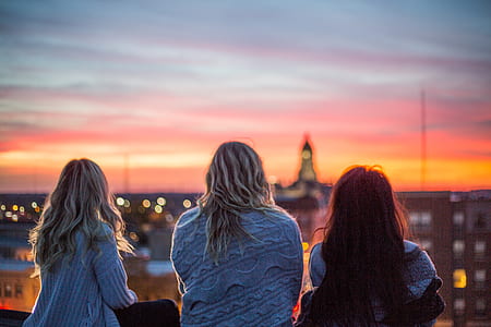 three woman seeing building during sunset thumbnail