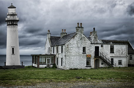 landscape photo of white house beside lighthouse thumbnail