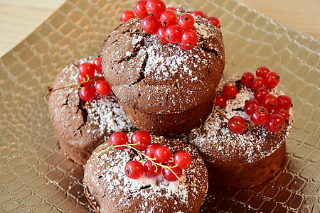 several brown cupcakes with red berries on top thumbnail