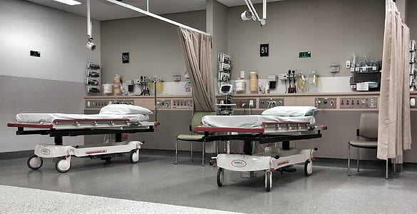 two white hospital beds inside medical room thumbnail