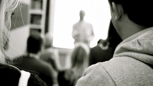 grayscale photography on man wearing hooded jacket thumbnail