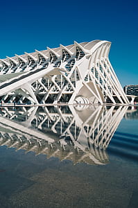 white concrete building beside body of water thumbnail
