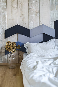 Designer bedroom with an ornamental golden plant in a jar by the bed thumbnail