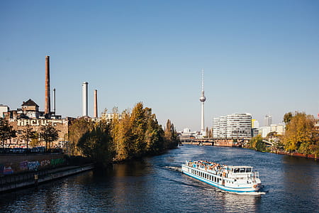Boat in a river in Berlin with city buildings in the background thumbnail