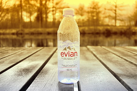 500 ml Evian water bottle on brown wooden surface thumbnail