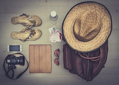 photography of brown hat on brown leather bag besides sunglasses, leather sandals, DSLR camera and silver iPhone 5s thumbnail
