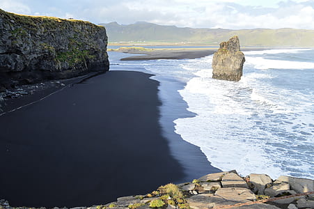 rock monolith beside water thumbnail